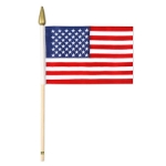 Fabric printed American flag attached to a wooden stick.