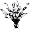 Weighed down black centerpiece with cascading metallic strands and wired skulls and bones