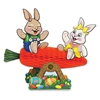 Tissue carrot placed on an axle to look like a seesaw with card stock bunnies riding it.