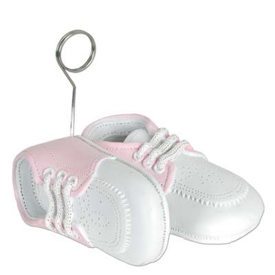 Balloon weights of pink baby shoes with metal balloon holder.