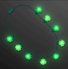 Necklace with shamrocks attached that lights up with LED lights. 
